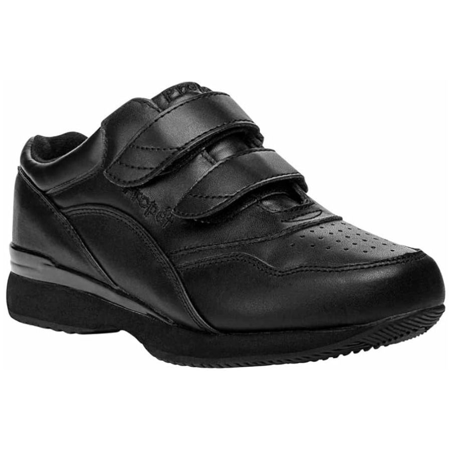 Black leather sneakers wit 2 velcro straps, perforated sections and thick outsole.